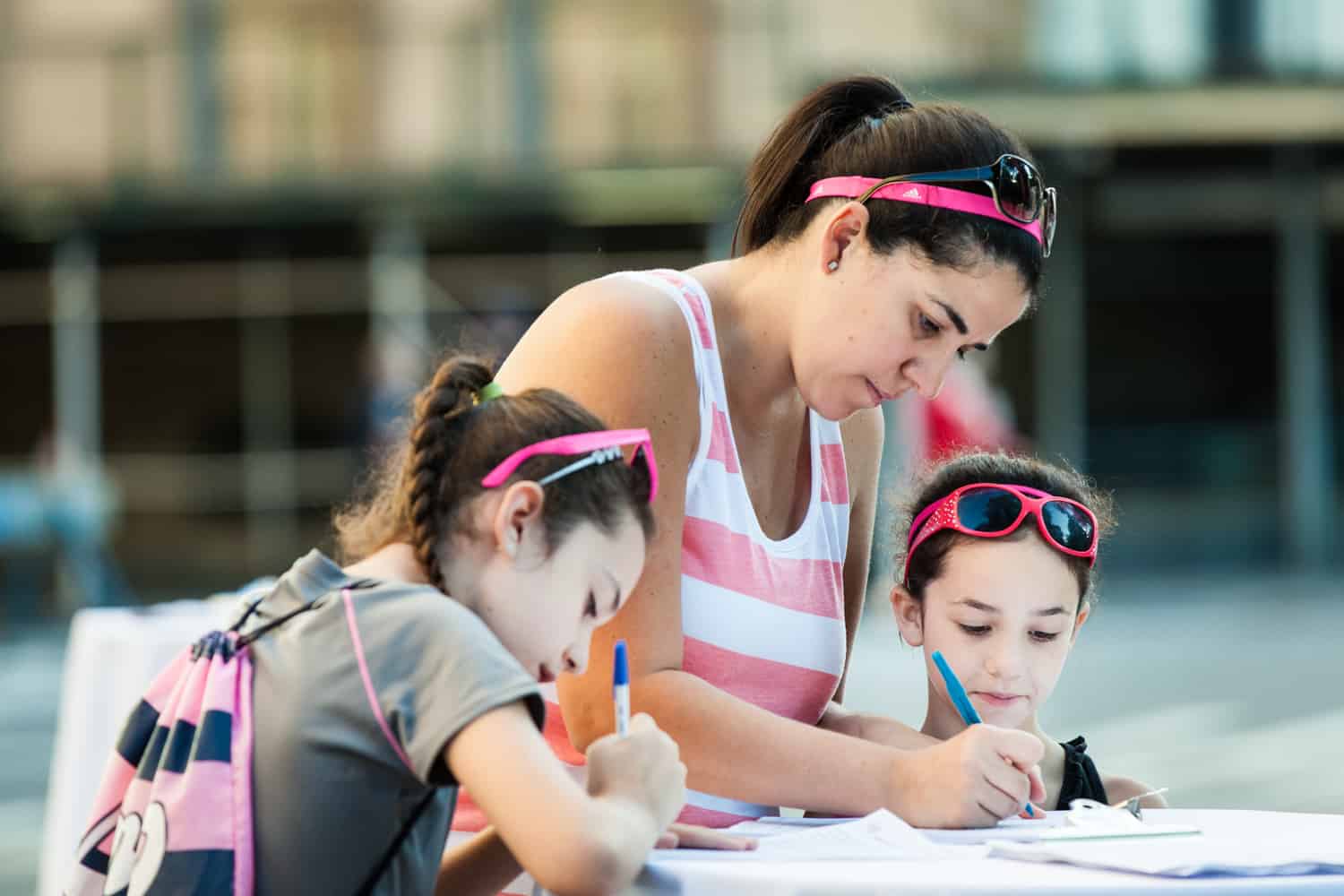 NYC Race for the Cure photos of woman and her two daughters filling out paperwork