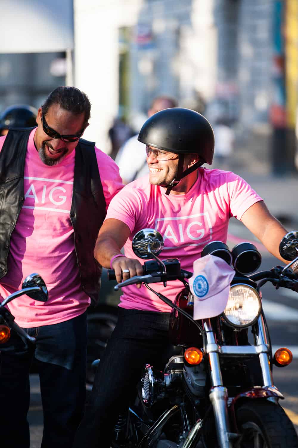 NYC Race for the Cure photos of man on motorcycle with helmet laughing with another anotherman