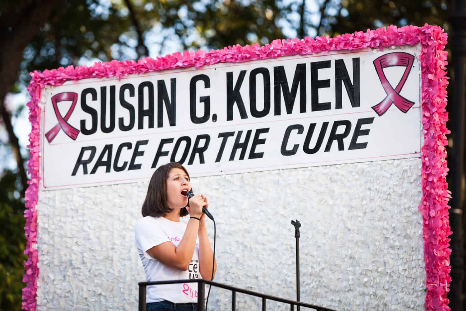 NYC Race for the Cure photos of woman singing on parade float