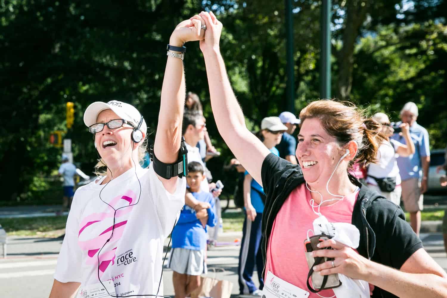 NYC Race for the Cure photos of two women crossing finish line with hands held in air