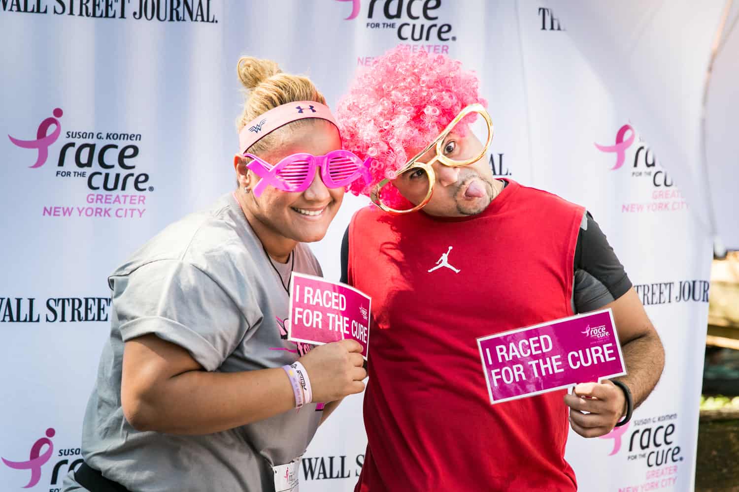 NYC Race for the Cure photos of couple clowning around at photobooth