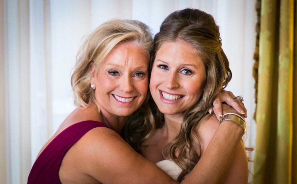 Mother and bride hugging before a University Club wedding