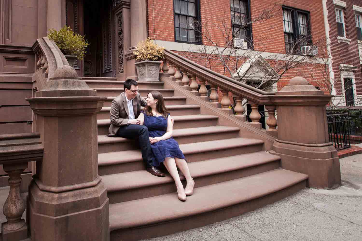 Brooklyn Promenade engagement photos of couple sitting on stairs of Brooklyn brownstone