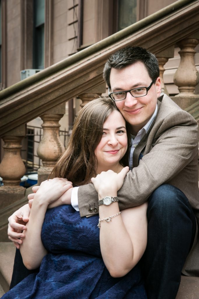 Brooklyn Promenade engagement photos of couple hugging on steps of brownstone