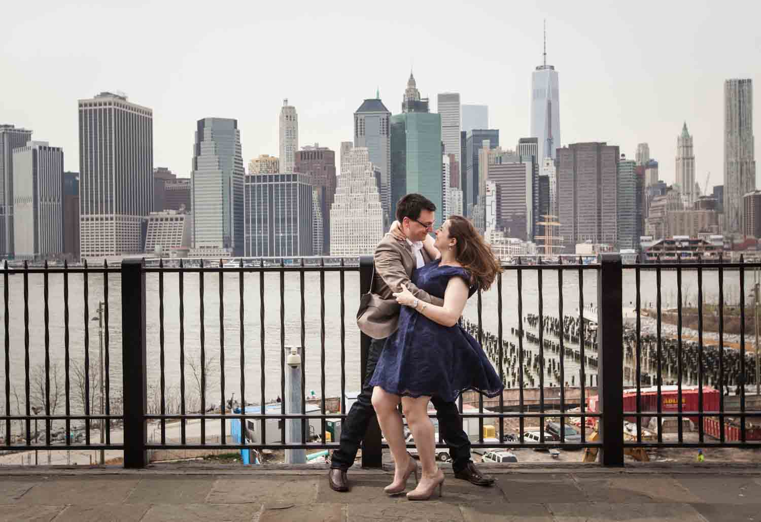 Couple dancing on Brooklyn Promenade with NYC skyline in background