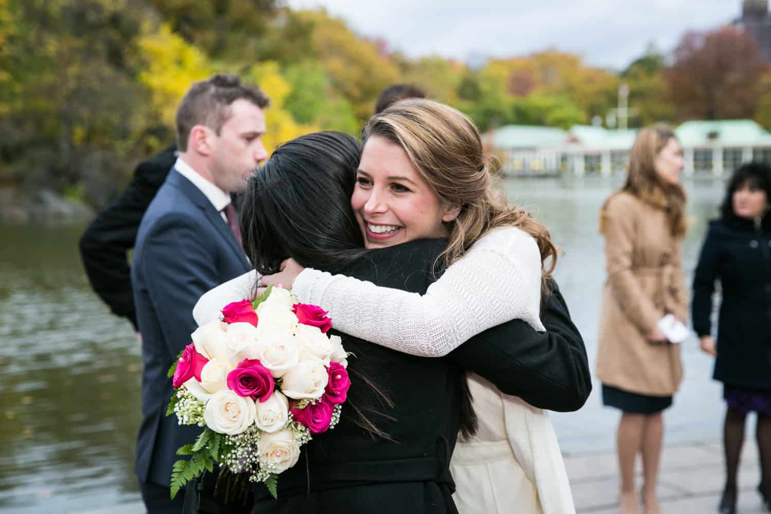 Bride hugging guest at a Bethesda Fountain wedding in Central Park