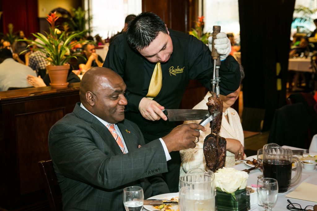 Waiter and guest selecting grilled meat at a Flushing Meadows Corona Park wedding
