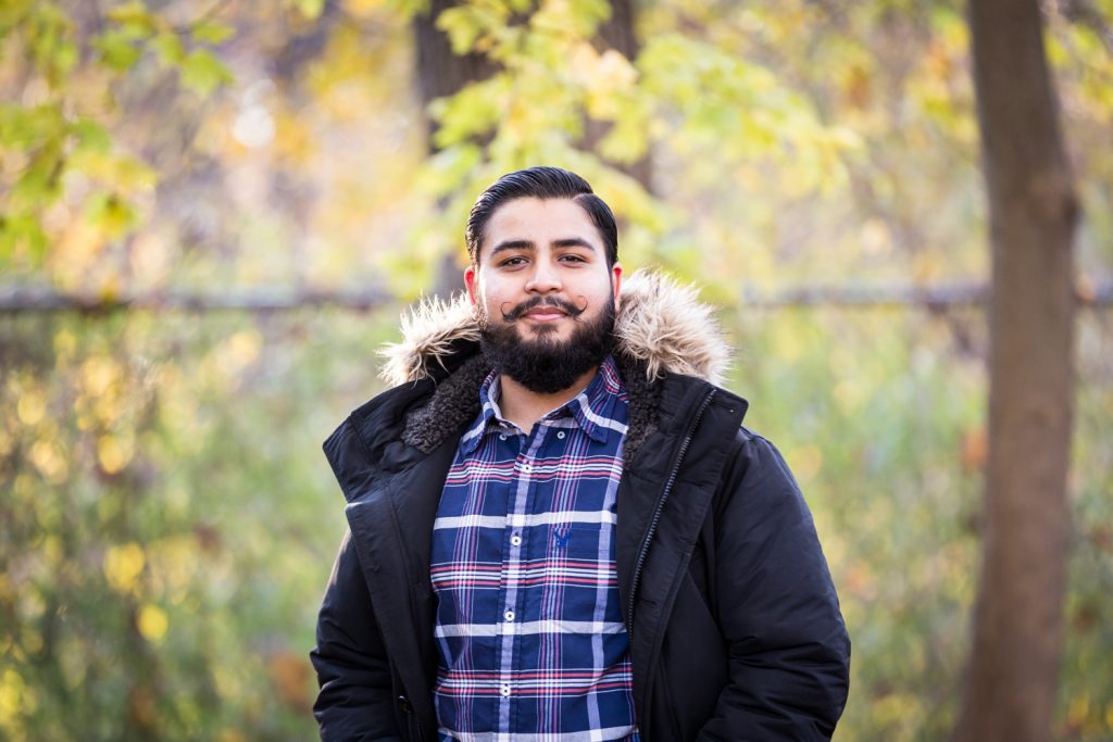 Man wearing coat in the forest for an article on how to look good in photos