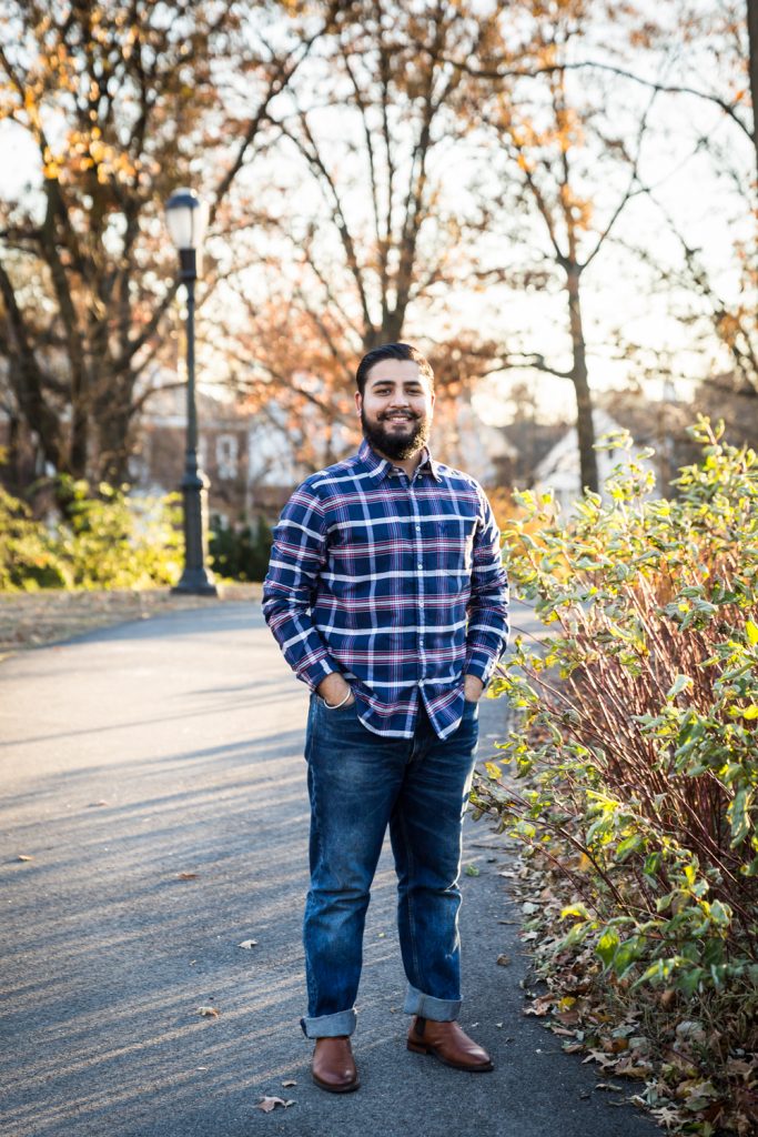 Man wearing plaid shirt in park for an article on how to look good in photos