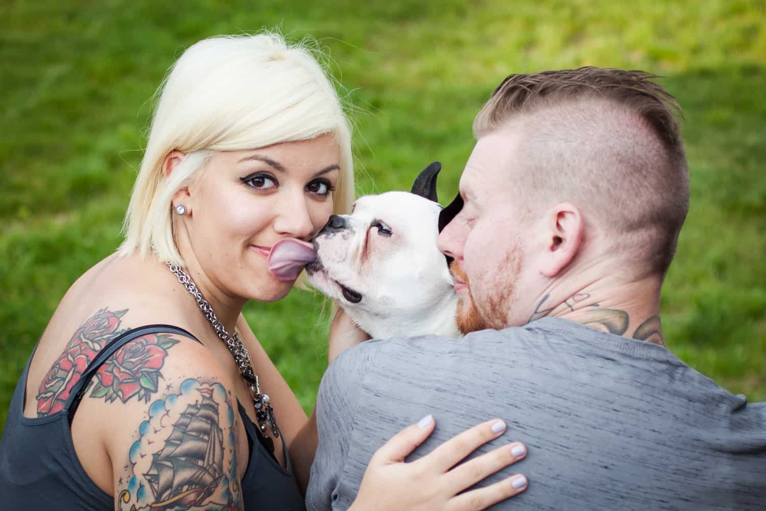 Dog licking blond woman with partner