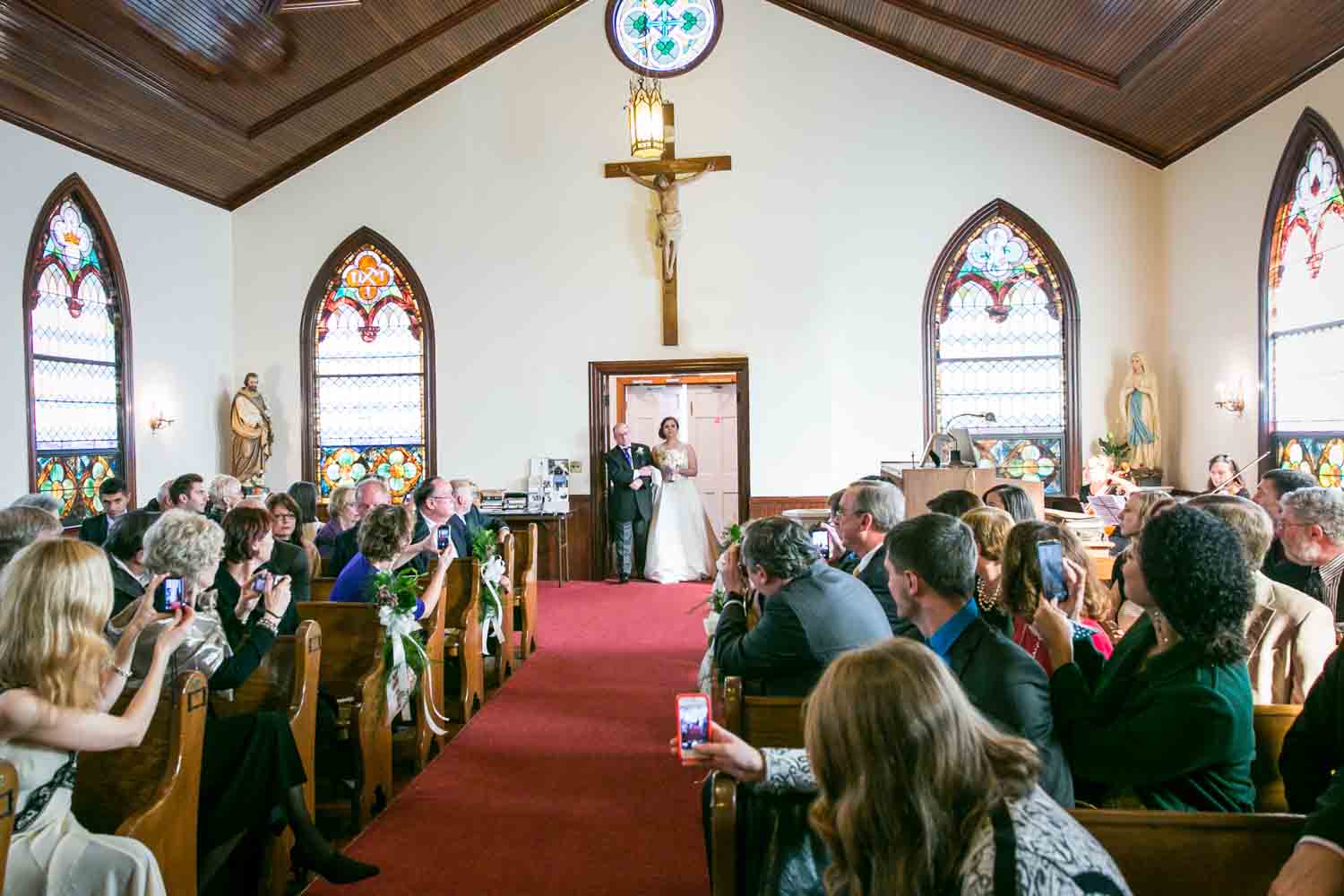 Wide shot of bride and father about to walk down aisle at St. James Church