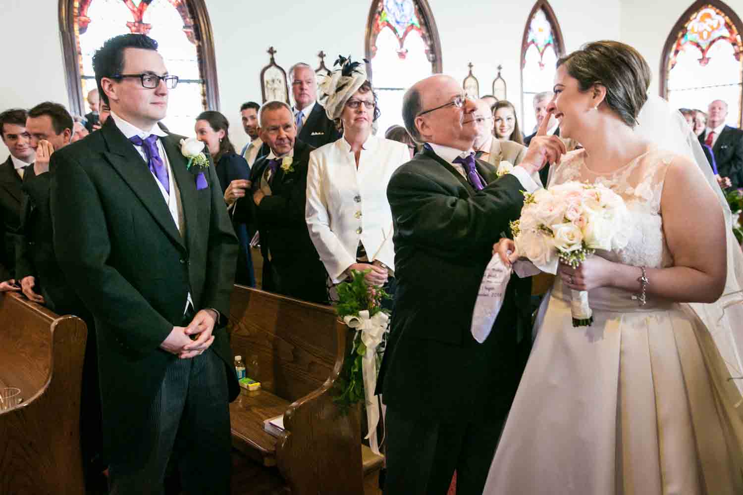Father giving bride away during ceremony at St. James Church