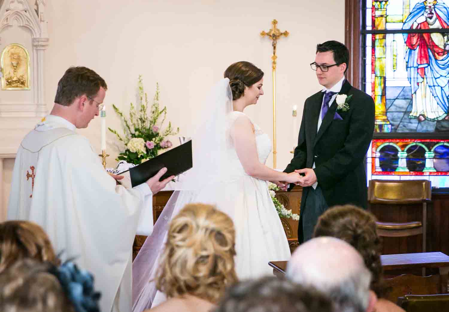 Bride and groom exchanging vows at St. James Church