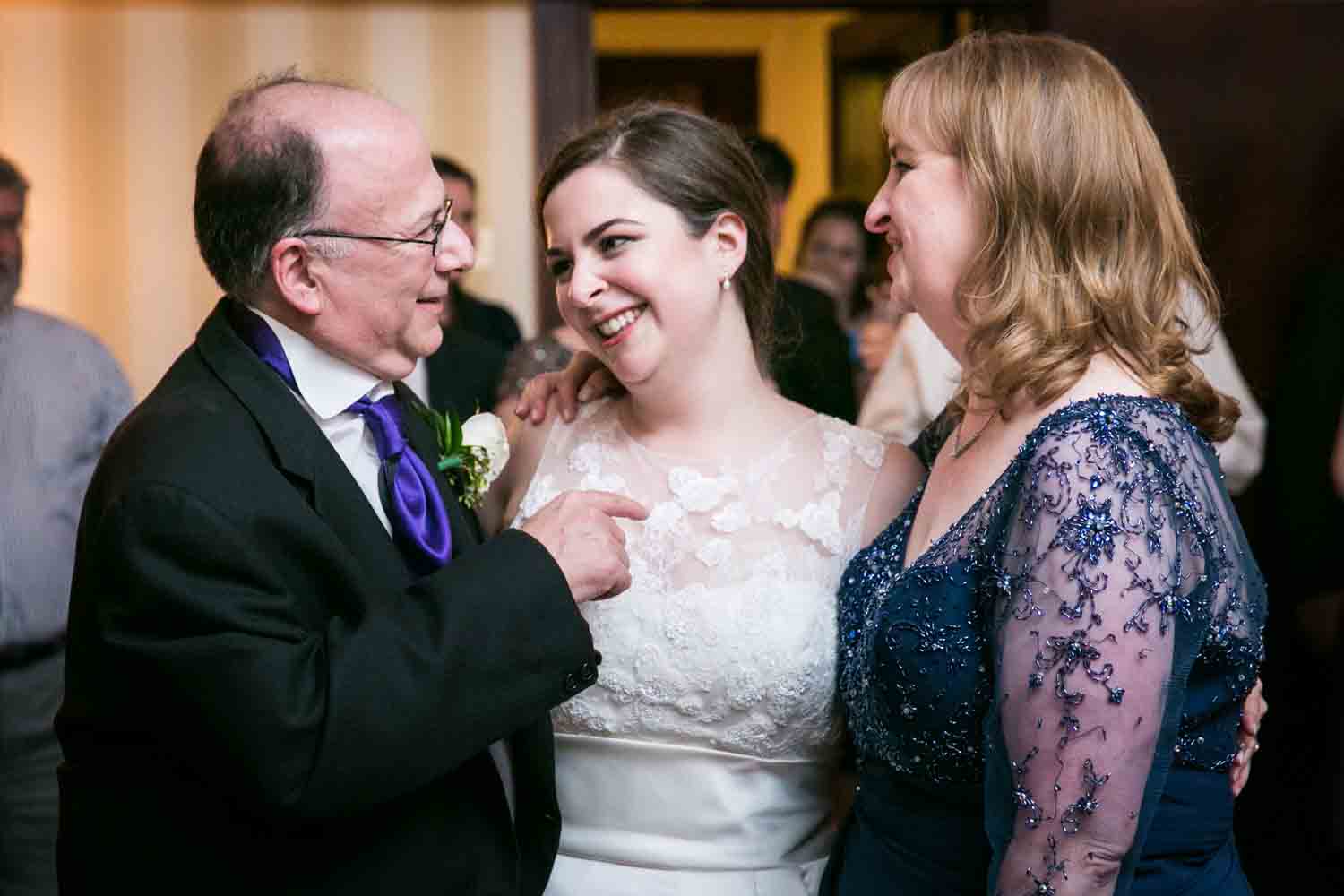 Bride laughing with both parents at a Nassau Inn wedding
