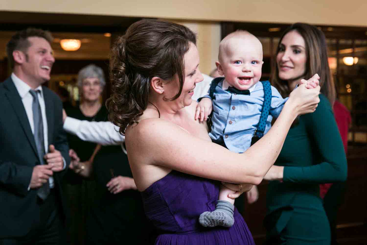 Woman dancing with baby at a Nassau Inn wedding