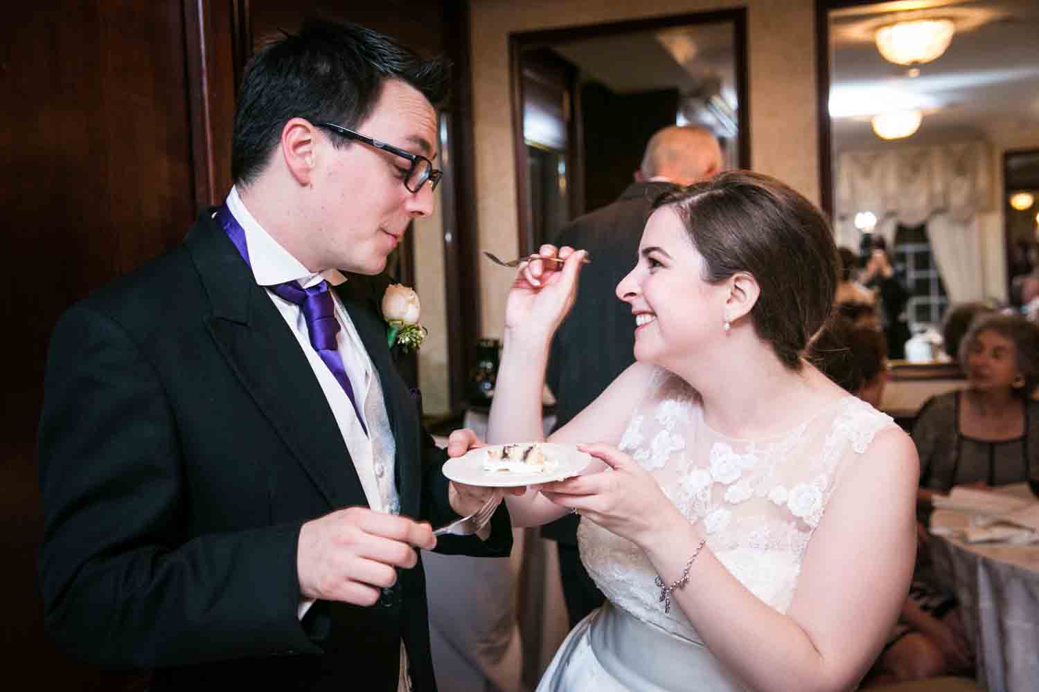 Bride feeding cake to groom at a Nassau Inn wedding