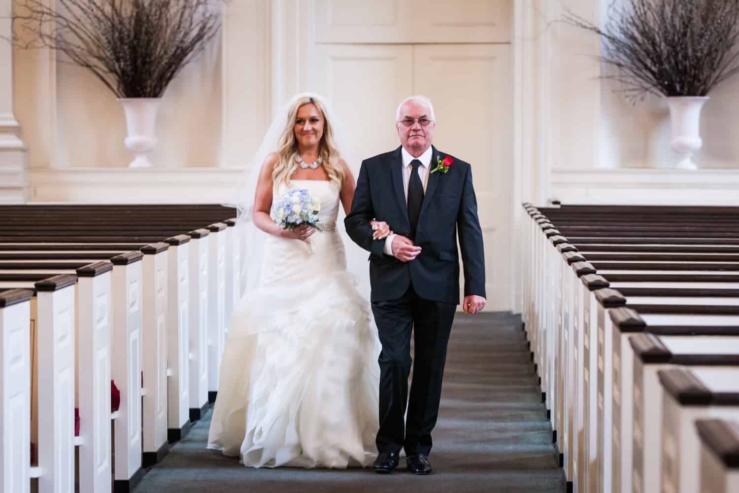 Bride and father walking down aisle during All Souls Unitarian Church ceremony