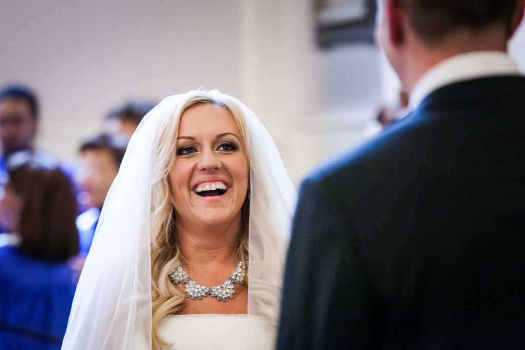 Bride laughing during All Souls Unitarian Church ceremony