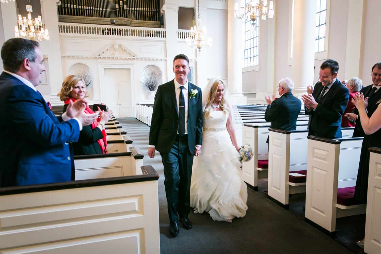 Bride and groom greeting guests during All Souls Unitarian Church ceremony