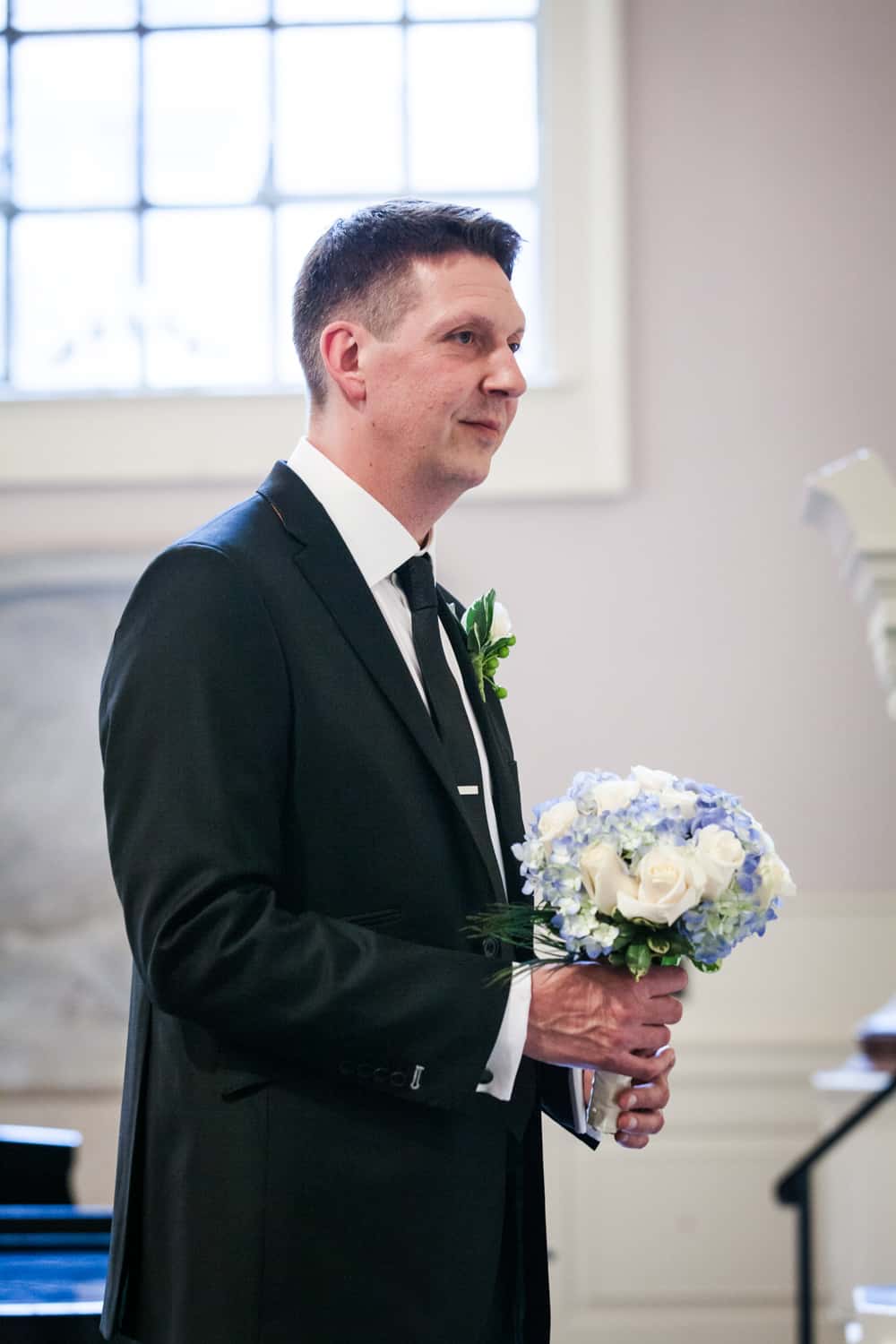 Groom holding bride's bouquet