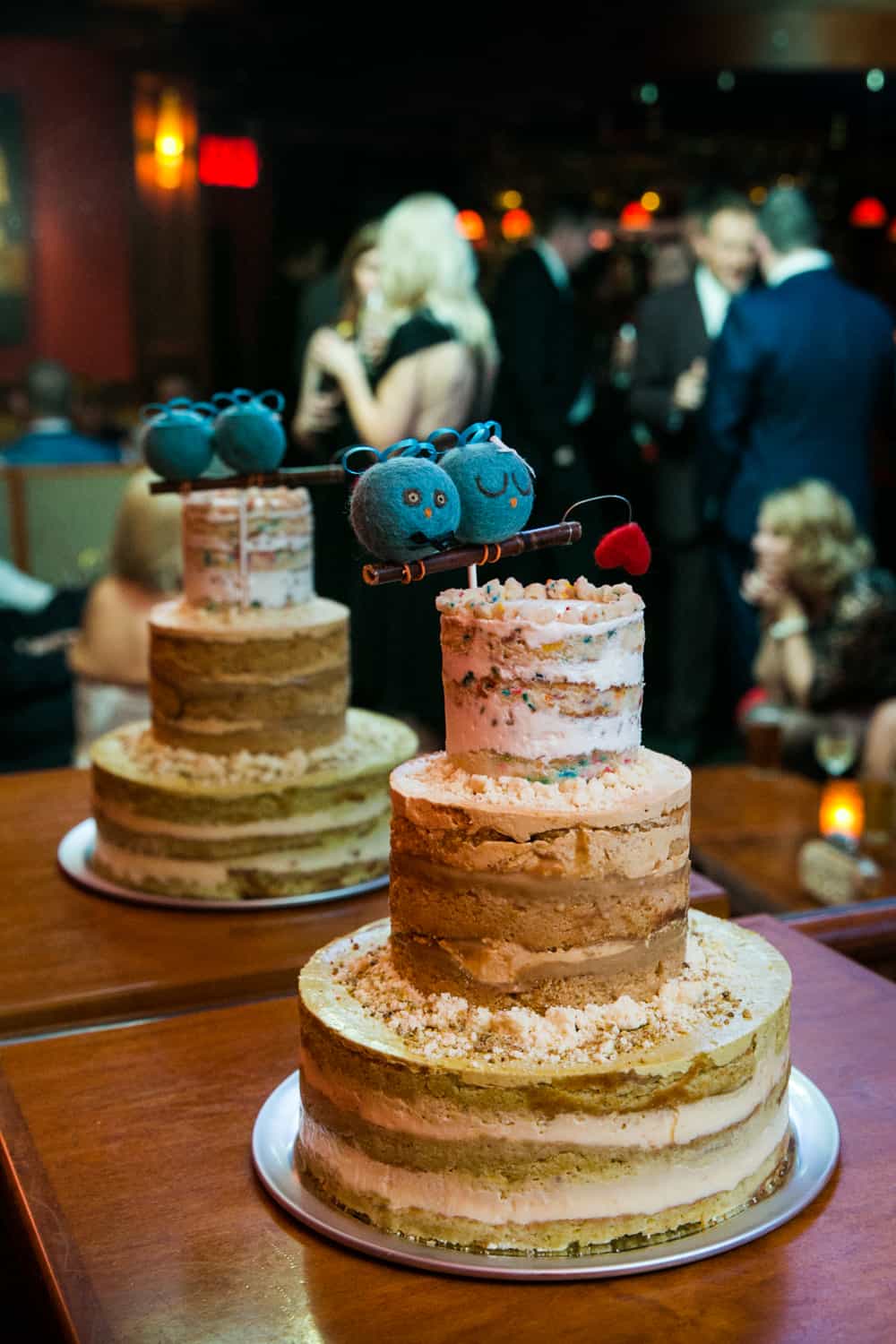 Wedding cake with blue bird topper at a Bergdorf Goodman wedding reception