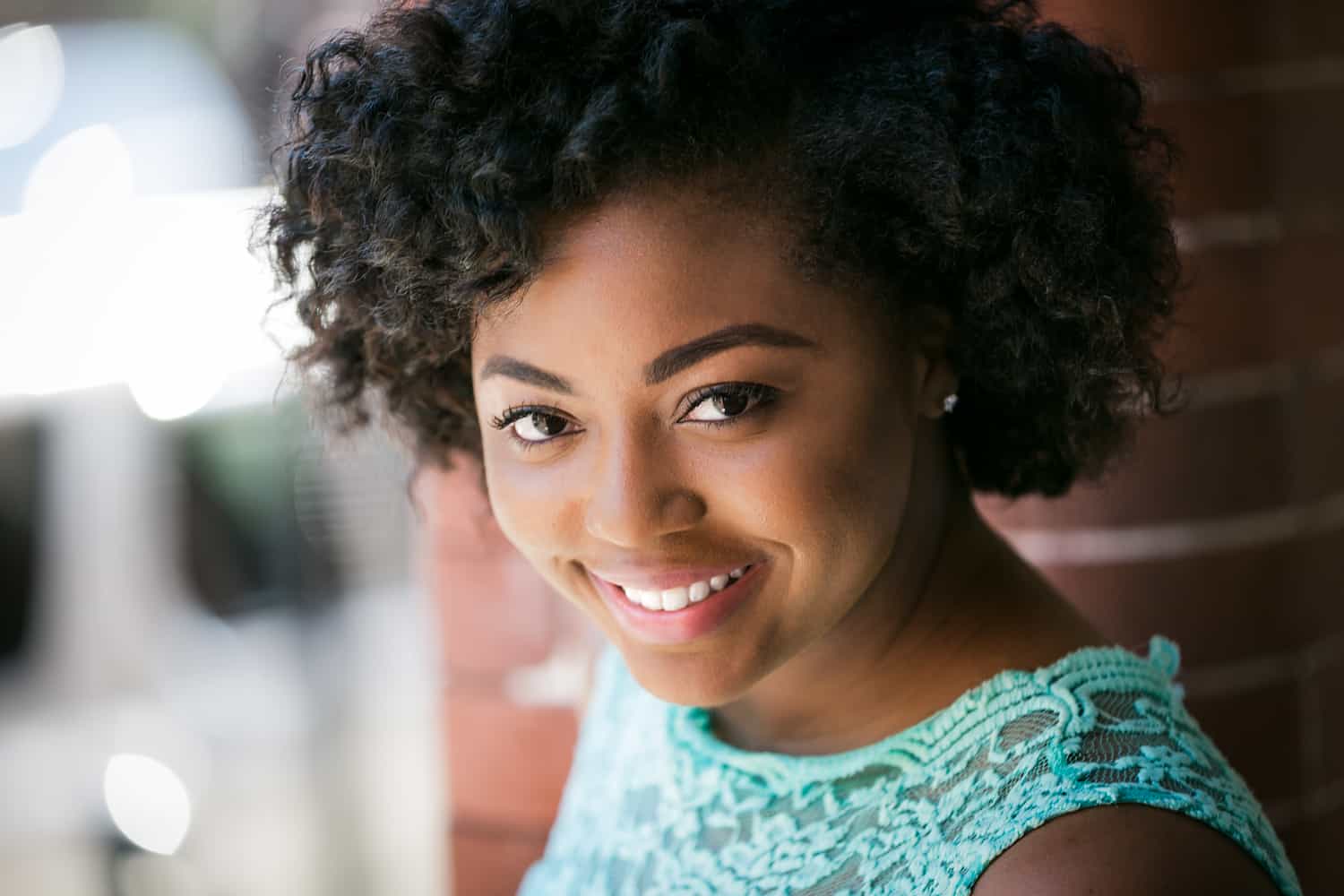 Headshot of African American model against brick wall