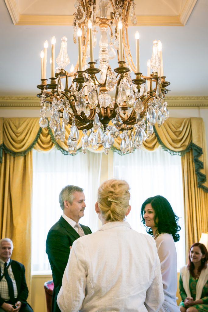 Bride and groom underneath chandelier at a Waldorf Astoria wedding