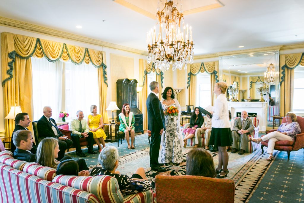 Wide shot of bride and groom exchanging vows at a Waldorf Astoria wedding