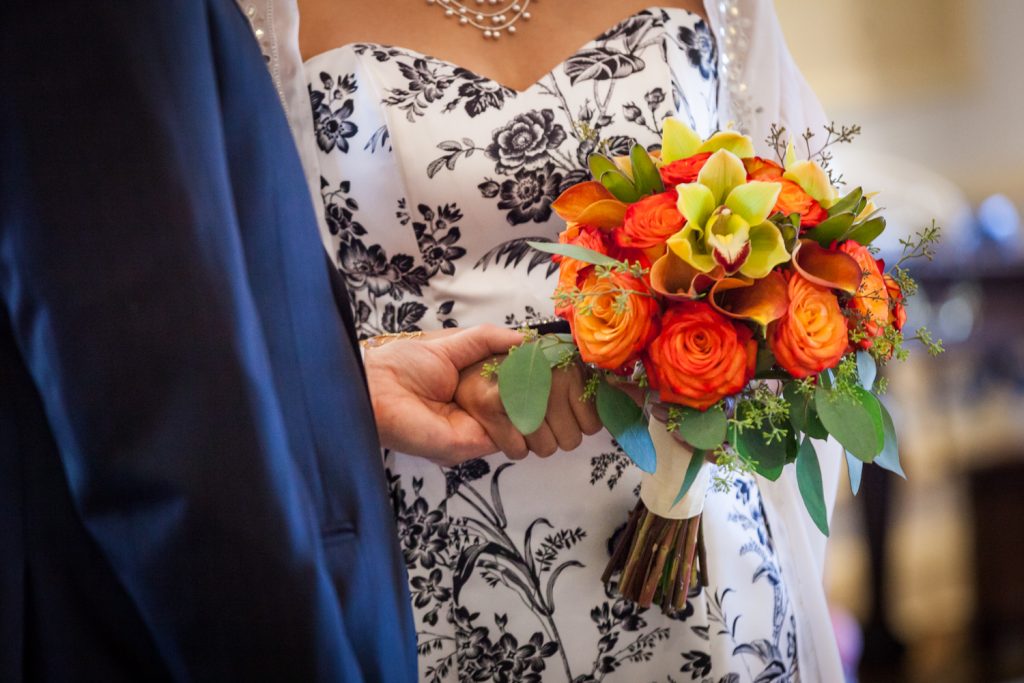 Close up on bride's orange flower bouquet at a Waldorf Astoria wedding