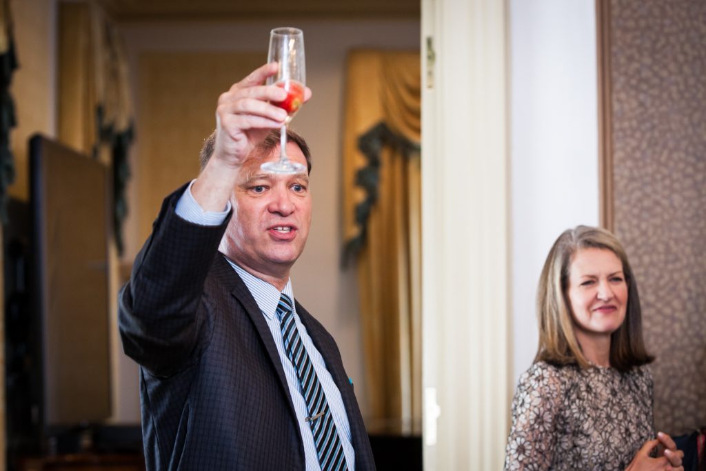 Guest raising glass of champagne at a Waldorf Astoria wedding