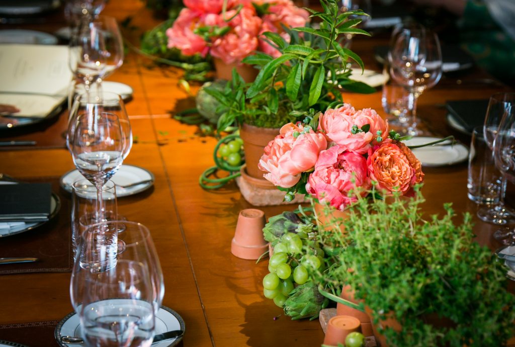 Place setting with red flowers at Gramercy Tavern wedding reception