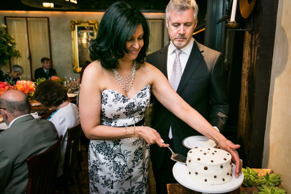 Bride and groom cutting wedding cake at Gramercy Tavern wedding reception