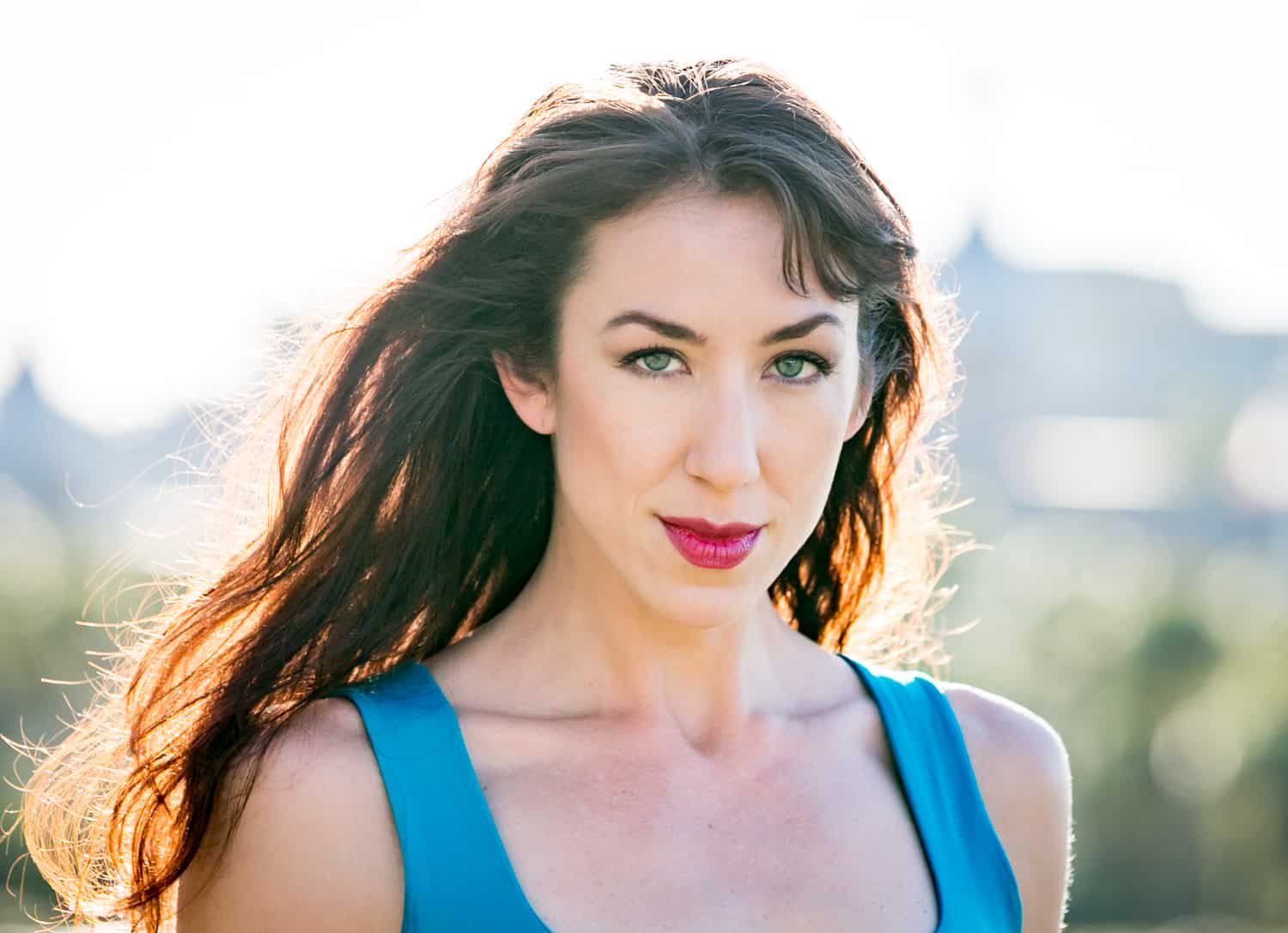 Acting headshots of model with long dark hair and blue tank top