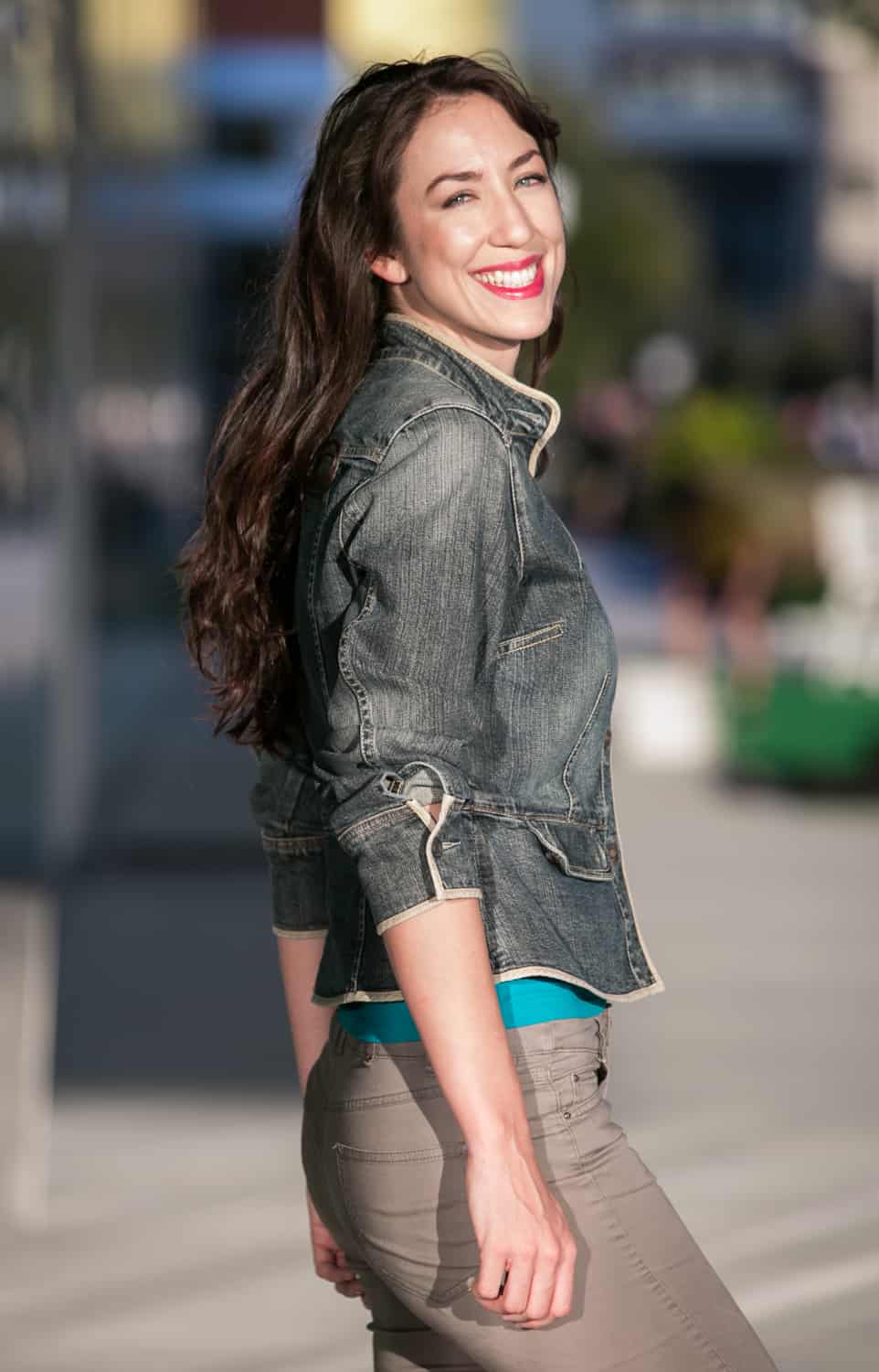 Headshot of model with long dark hair and jean jacket
