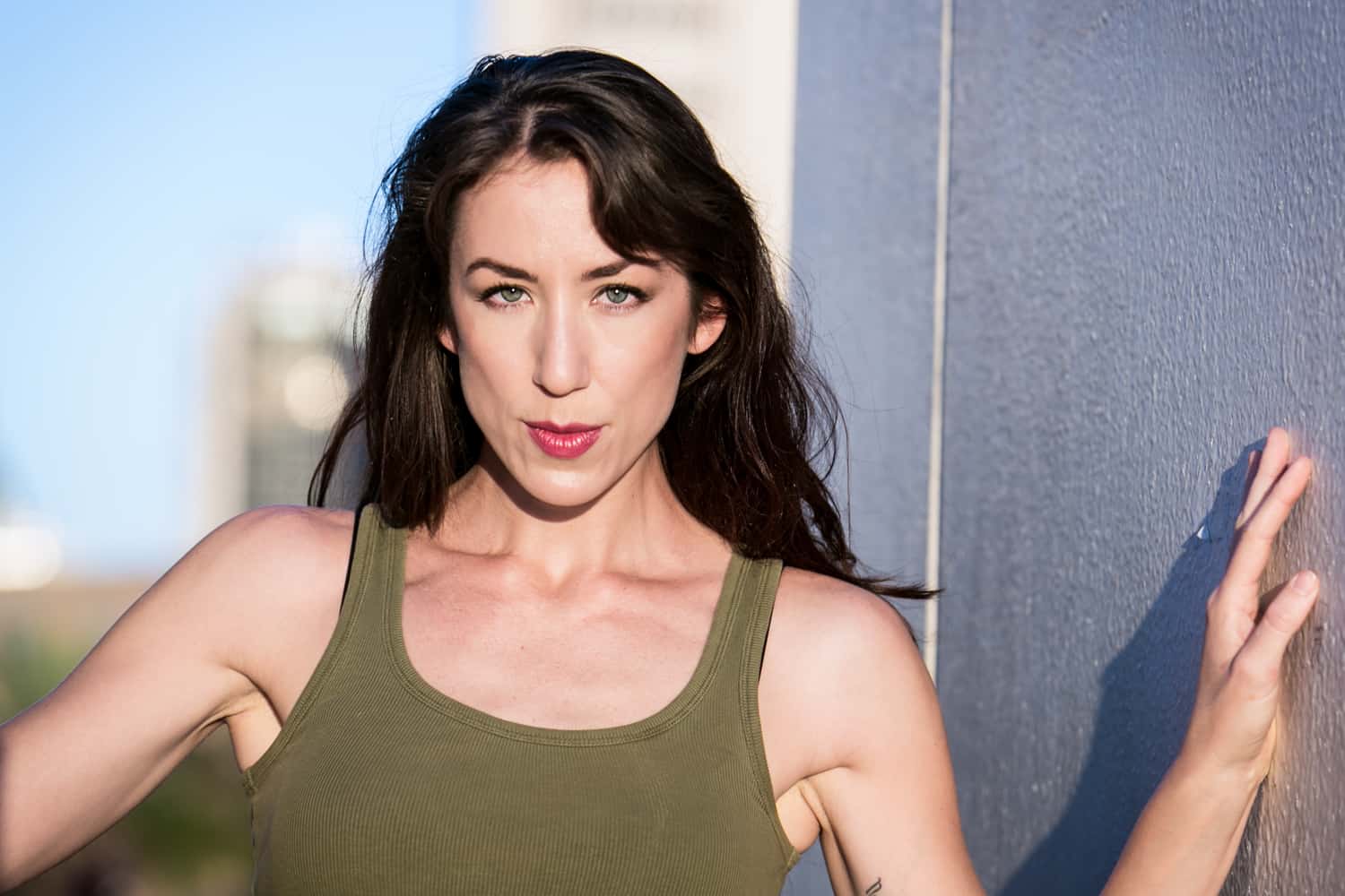 Acting headshot of model with long dark hair and olive tank top