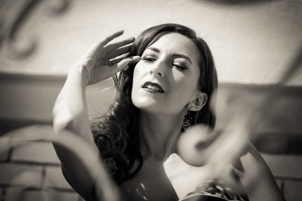 Black and white photo of pinup model wearing leopard print bikini top