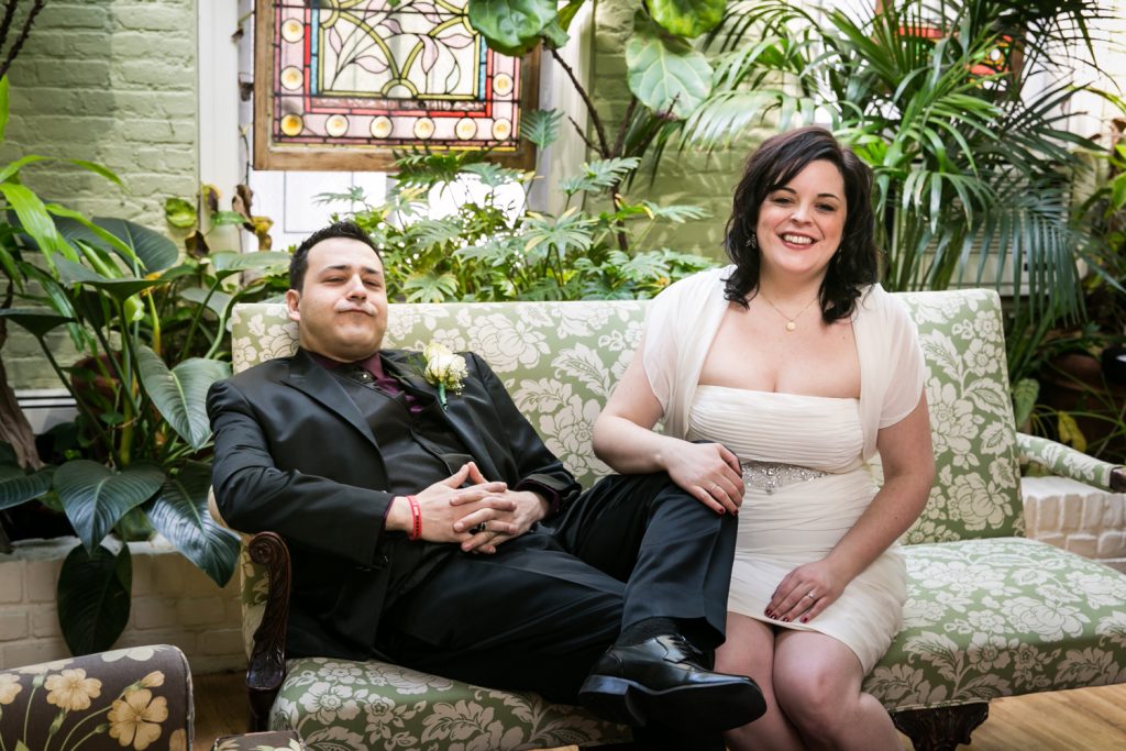 Bride and groom sitting on couch at an Alger House wedding ceremony