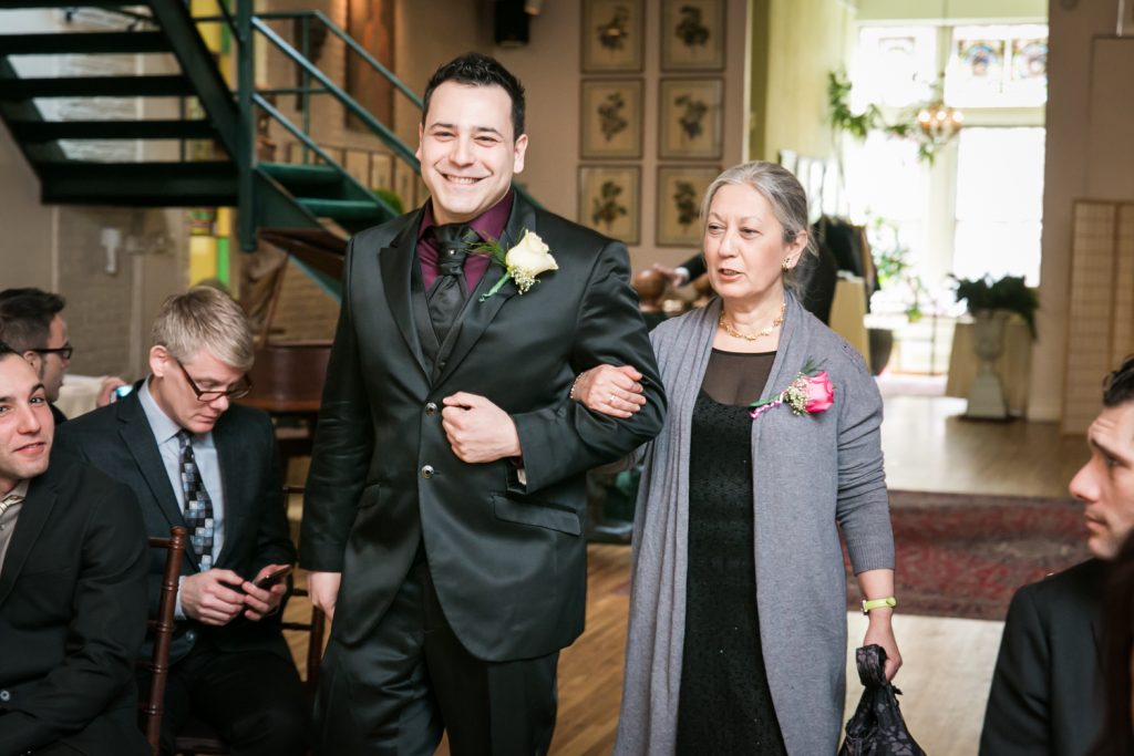 Groom and mother walking down aisle at an Alger House wedding ceremony