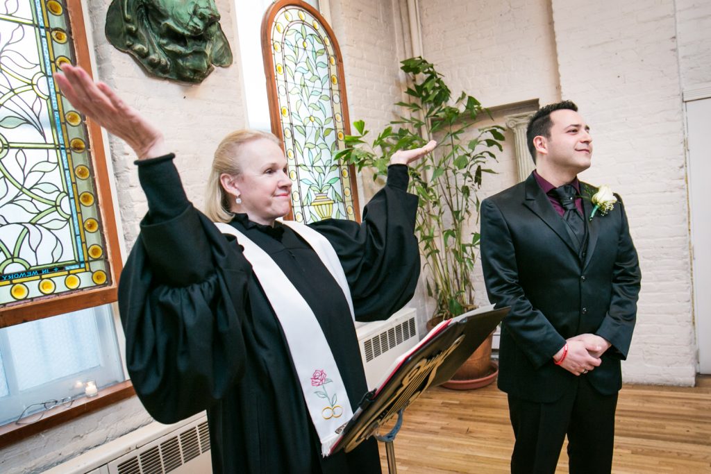 Officiant with arms up and groom waiting for bride at an Alger House wedding ceremony