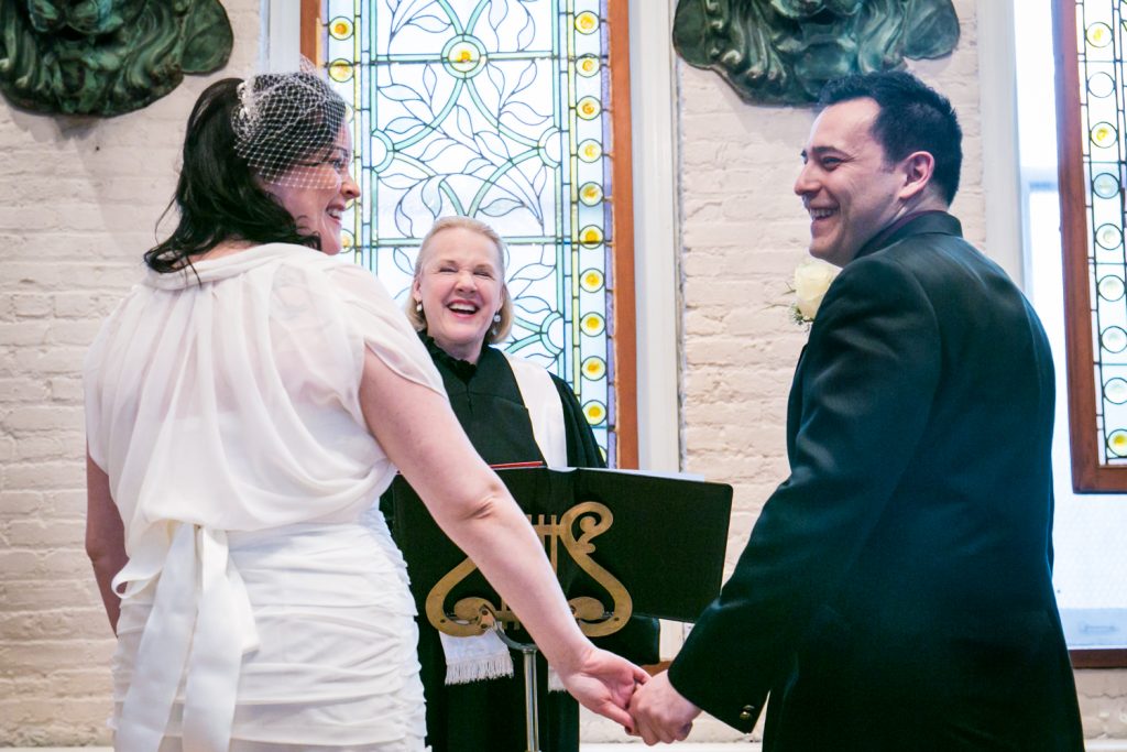 Bride and groom with officiant at an Alger House wedding ceremony