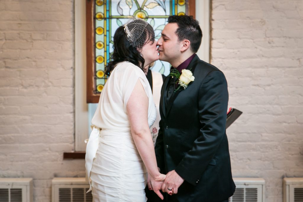 Bride and groom kissing at an Alger House wedding ceremony