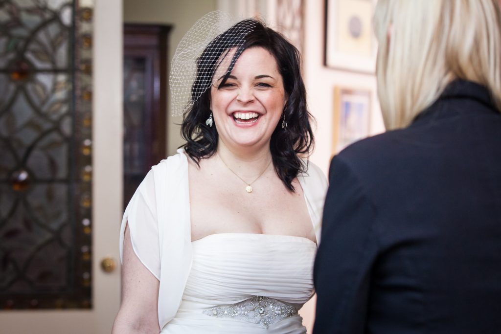 Bride laughing at Alger House wedding reception