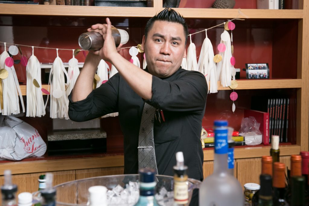 Birthday party photos of bartender shaking cocktail shaker