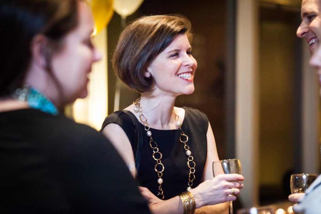 Birthday party photos of woman with short brown hair smiling