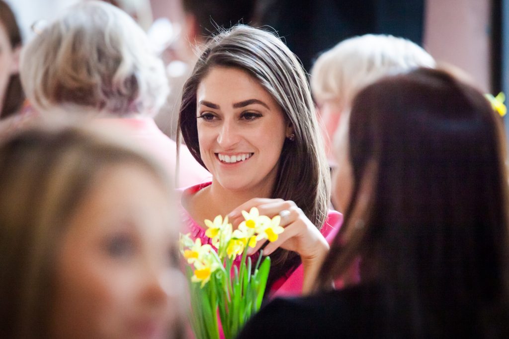 Bride smiling over daffodils at a NYC bridal shower