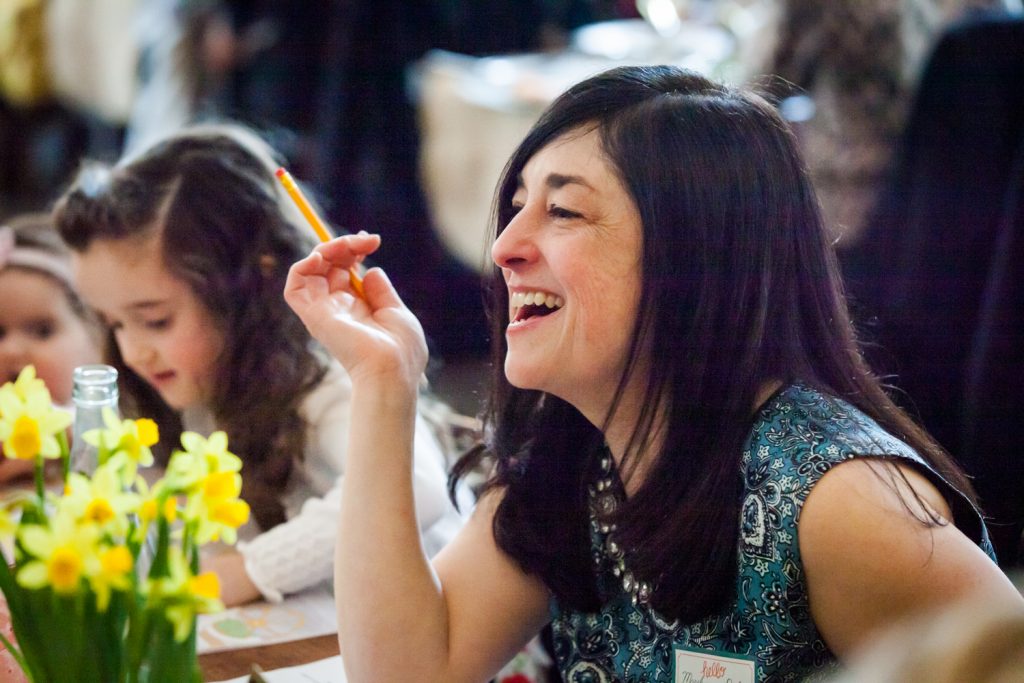 Woman with black hair laughing at a NYC bridal shower