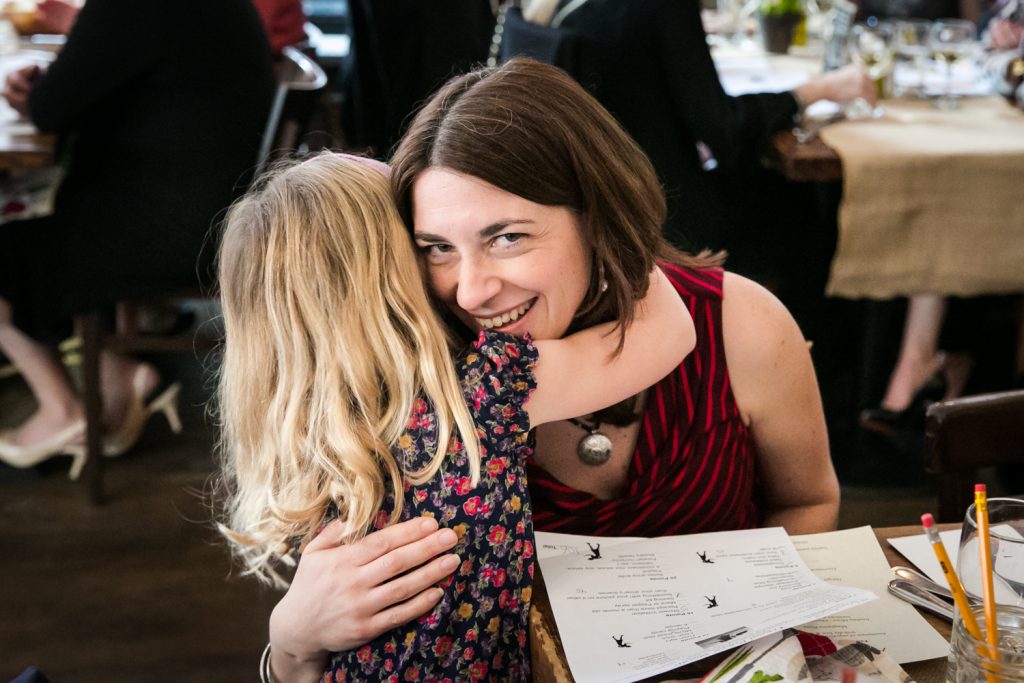 Woman hugging child at a NYC bridal shower