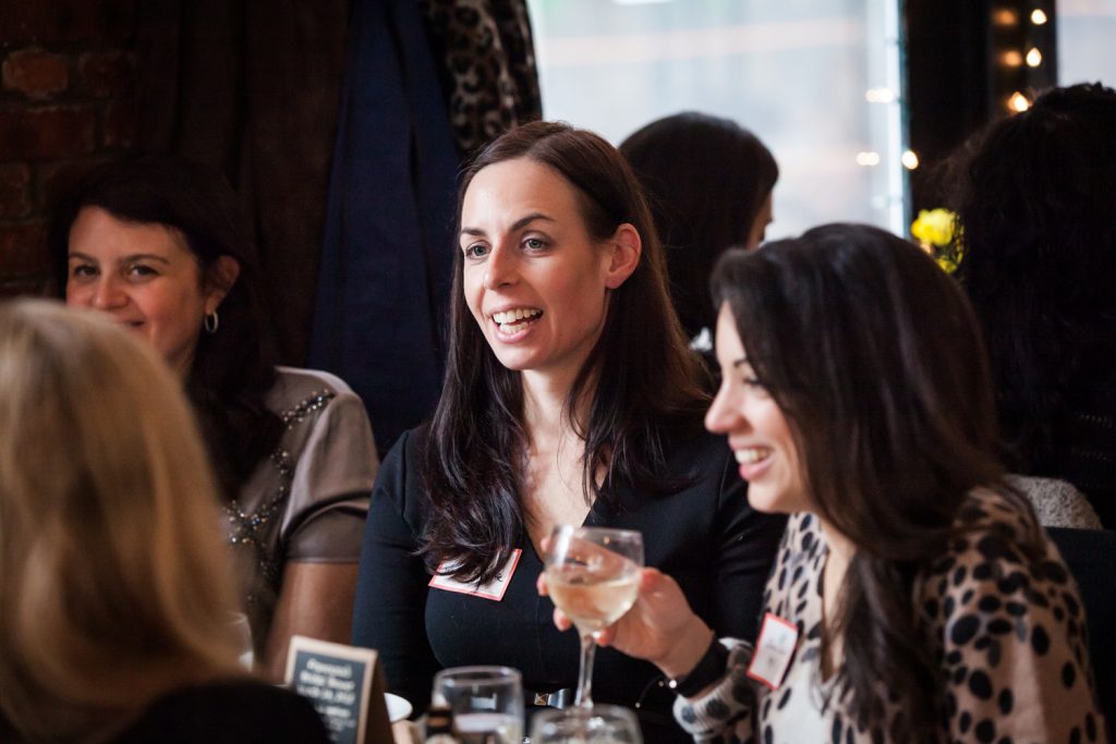 Female guests chatting at table at a NYC bridal shower