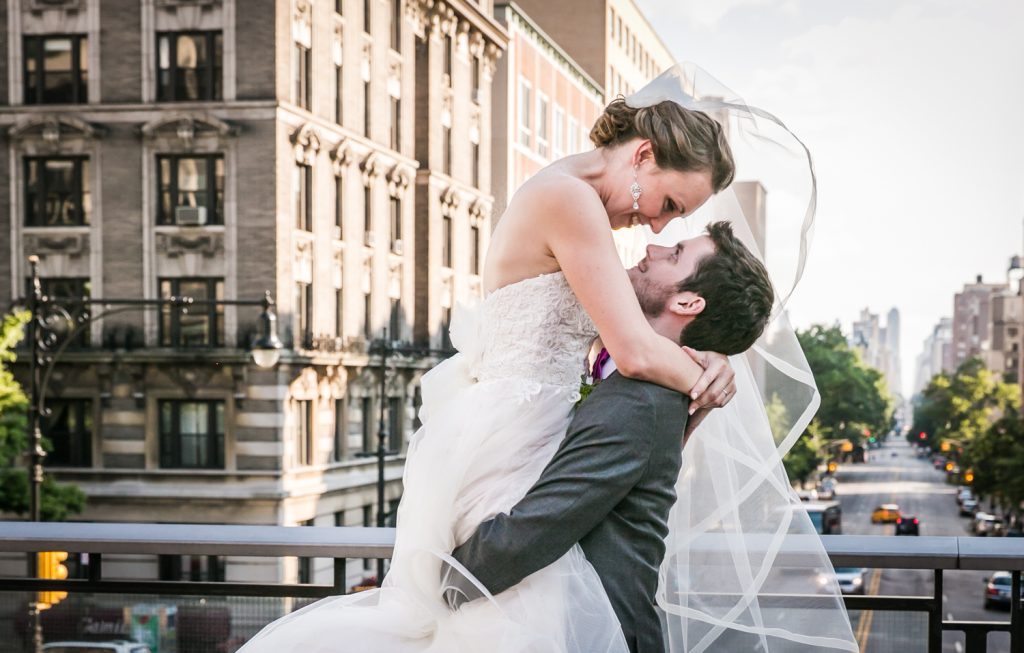 Groom picking up bride for an article on how to get the wedding photos you want