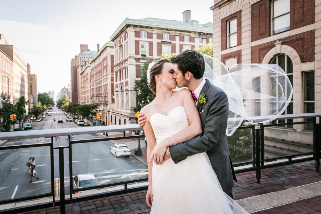 Bride and groom kissing on NYC rooftop for an article on how to get the wedding photos you want